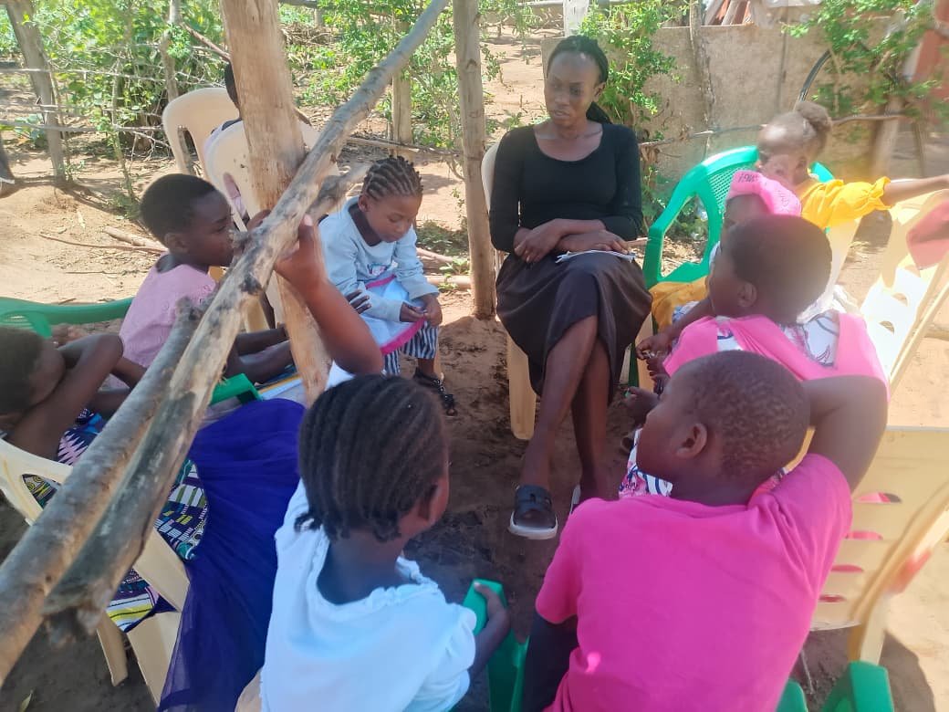 Outdoor children’s Bible class in plastic chairs